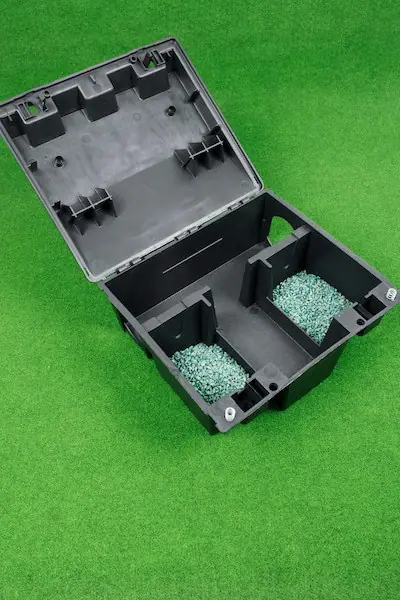 Rat bait station with bait blocks on grass